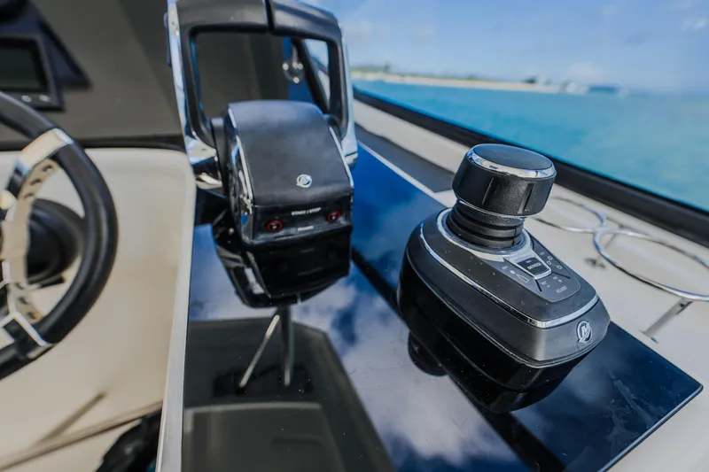 Slide: The Image of Control panel of 2023 Aquila 36 Sport yacht with steering and throttle. - 34