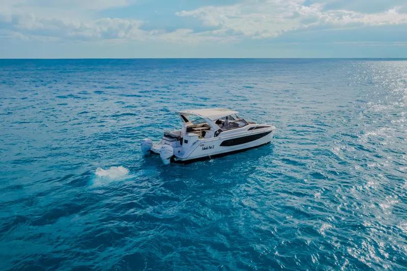 Slide: The Image of 2023 Aquila 36 Sport yacht cruising on open blue ocean under clear sky. - 59