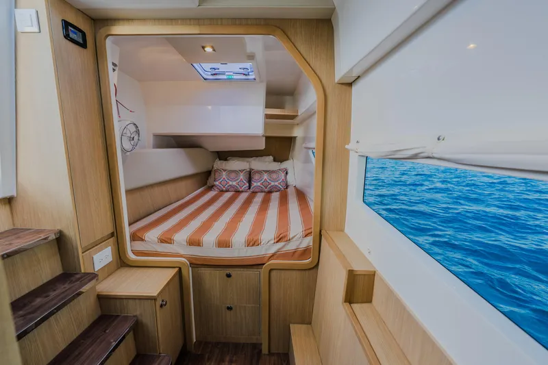 Slide: The Image of 2023 Aquila 36 Sport cabin interior with bed, ocean view window. - 46