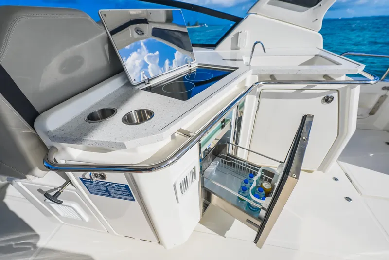 Slide: The Image of 2023 Aquila 36 Sport yacht kitchenette with open fridge and ocean view. - 25