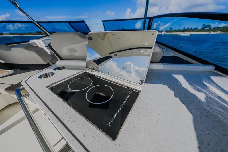 Slide: The Image of 2023 Aquila 36 Sport yacht with sleek outdoor kitchen and ocean view. - 26