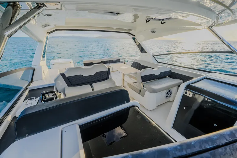 Slide: The Image of 2023 Aquila 36 Sport boat interior with seating, table, and ocean view. - 55