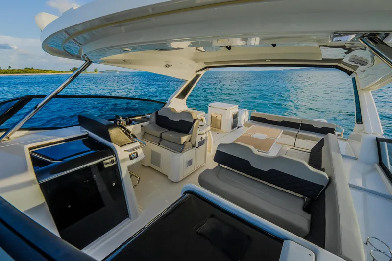 Slide: The Image of Interior view of 2023 Aquila 36 Sport yacht with luxurious seating and ocean backdrop. - 56