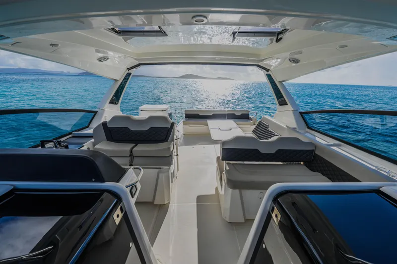 Slide: The Image of 2023 Aquila 36 Sport yacht interior with ocean view, featuring modern seating and sleek design. - 31