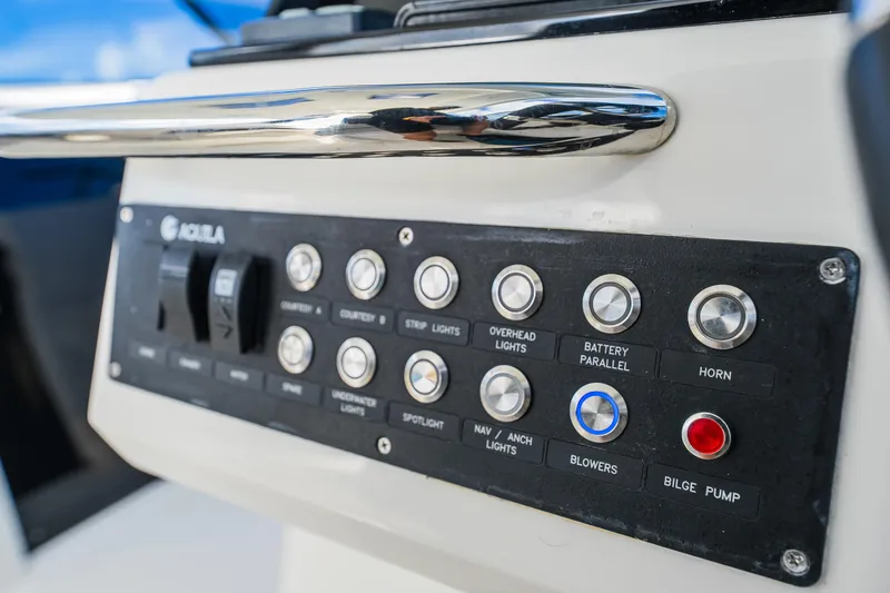 Slide: The Image of Control panel of 2023 Aquila 36 Sport boat with various switches and buttons. - 35