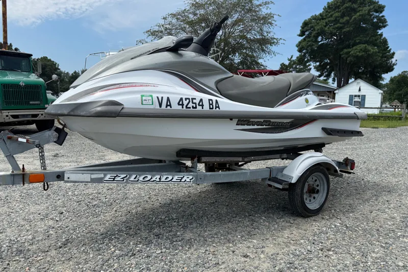 The Image of 2002 Yamaha WaveRunner FX on trailer, parked outdoors on gravel. - 0