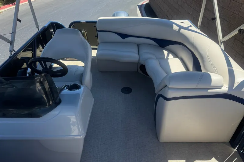 Slide: The Image of 2020 Aloha Pontoon Tropical TS 220 interior with plush seating and steering console. - 15