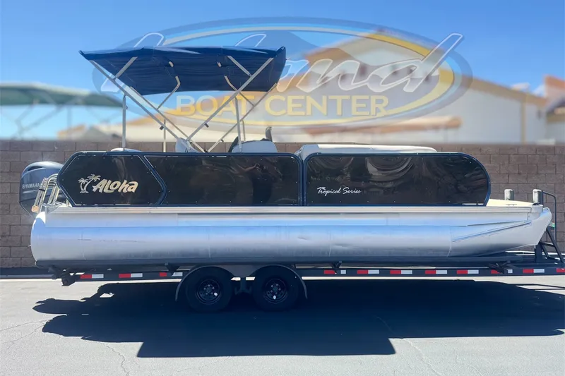 The Image of 2020 Aloha Pontoon Tropical TS 220 on trailer, displayed at a boat center. - 0