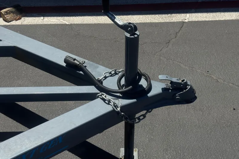 Slide: The Image of Trailer hitch of a 2020 Aloha Pontoon Tropical TS 220 on asphalt. - 23