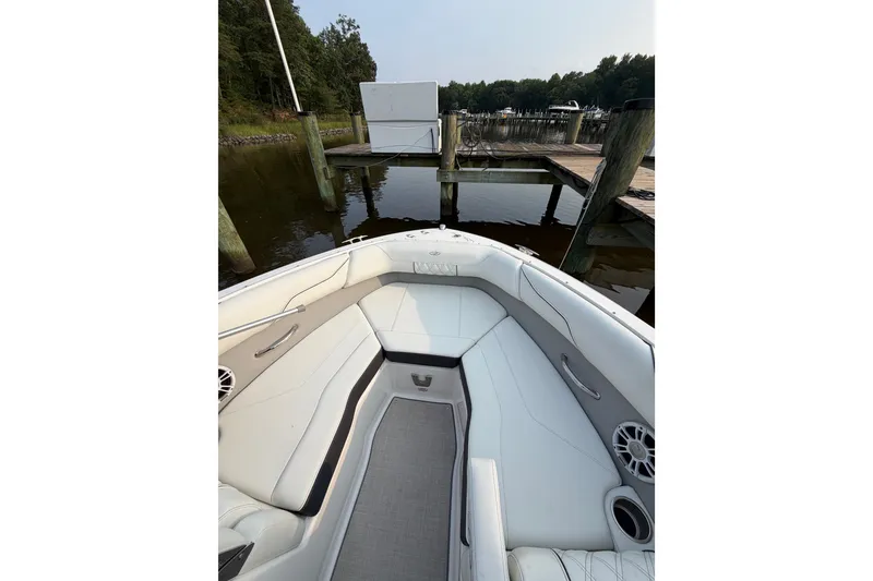 Slide: The Image of 2023 Regal LX2 boat interior with white seating at a dock. - 6