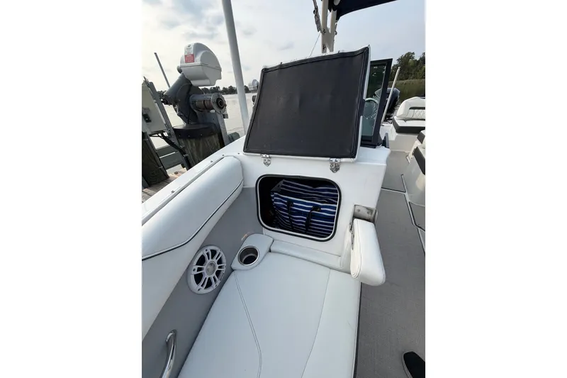 Slide: The Image of 2023 Regal LX2 boat interior with open storage compartment and seating area. - 8