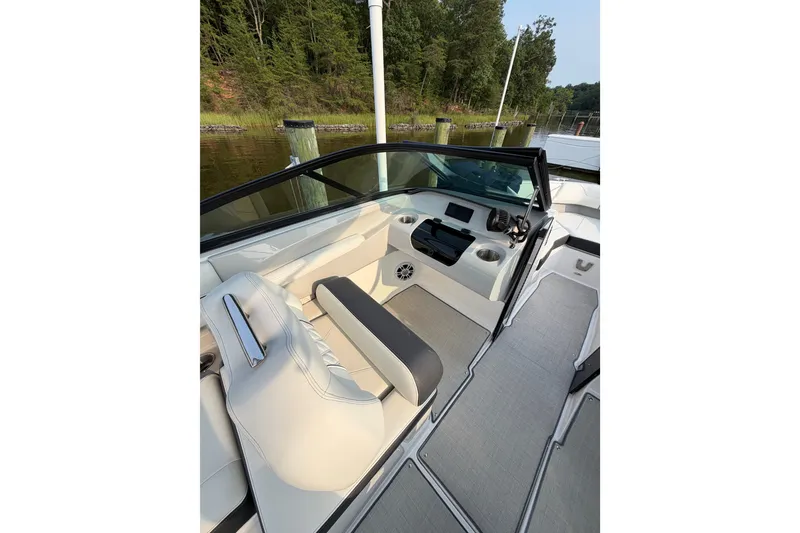 Slide: The Image of 2023 Regal LX2 boat interior with sleek seating and modern dashboard design. - 15