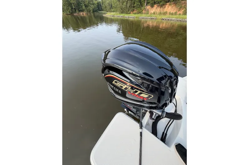 Slide: The Image of 2023 Regal LX2 boat with Yamaha VMAX outboard motor on a calm lake. - 18