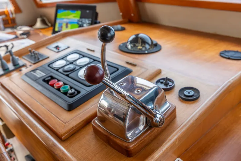 Slide: The Image of Control panel of a 1990 Kadey-Krogen 42 boat with throttle levers and navigation instruments. - 35