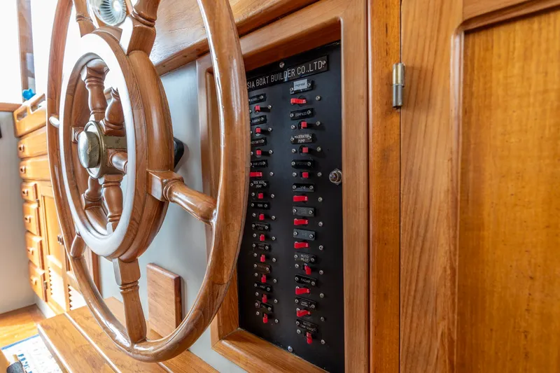 Slide: The Image of Wooden helm and control panel on a 1990 Kadey-Krogen 42 boat. - 37