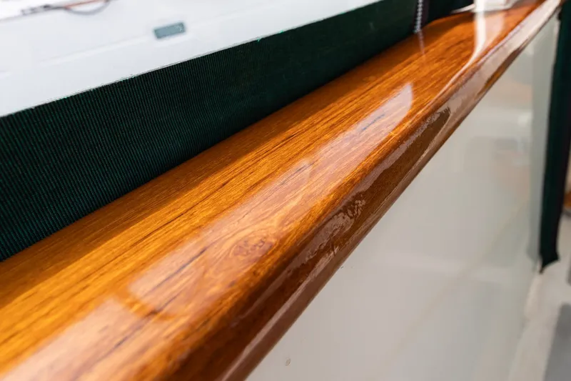 Slide: The Image of Polished wooden railing on a 1990 Kadey-Krogen 42 boat, showcasing craftsmanship. - 16