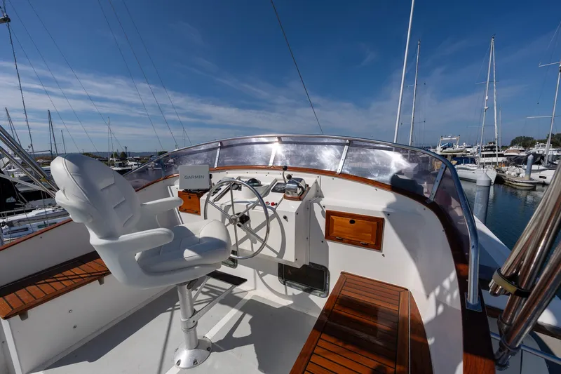 Slide: The Image of Helm of 1990 Kadey-Krogen 42 yacht with steering wheel and navigation equipment. - 53