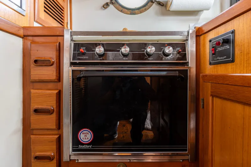 Slide: The Image of 1990 Kadey-Krogen 42 yacht kitchen with Seaward Princess oven and wooden cabinetry. - 25