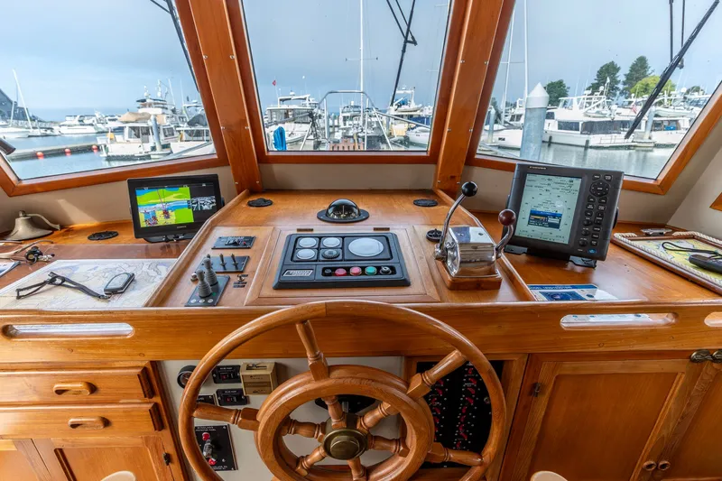 Slide: The Image of Helm of 1990 Kadey-Krogen 42 yacht with navigation equipment and wooden steering wheel. - 7