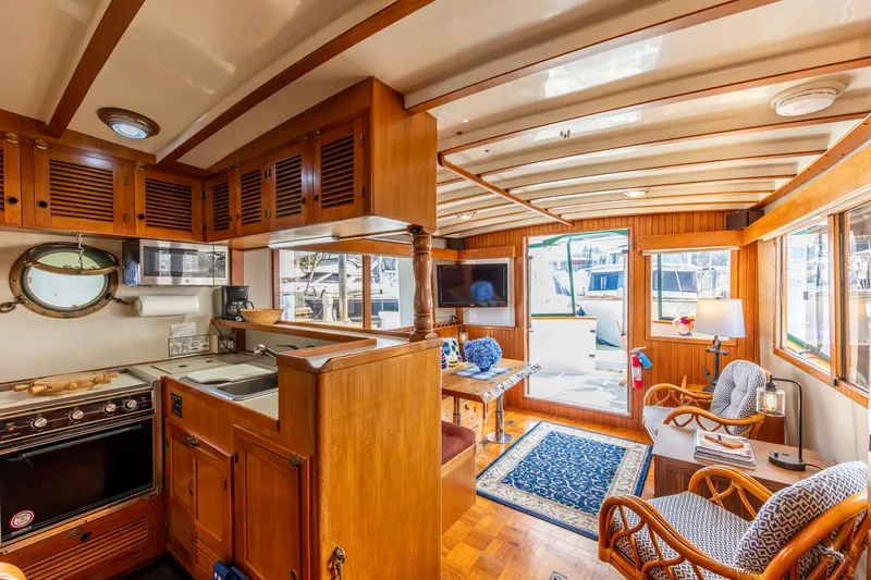 Slide: The Image of Interior of a 1990 Kadey-Krogen 42 yacht with wooden cabinetry and cozy seating area. - 4