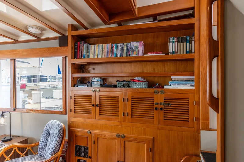 Slide: The Image of Interior of 1990 Kadey-Krogen 42 yacht with wooden shelves and books. - 23