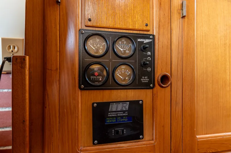 Slide: The Image of Control panel on 1990 Kadey-Krogen 42 boat, featuring gauges and switches. - 22