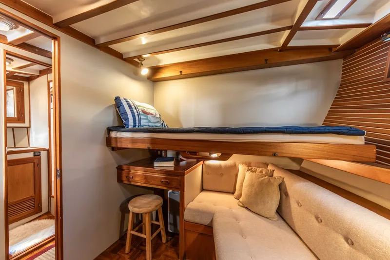 Slide: The Image of Cozy cabin interior of 1990 Kadey-Krogen 42 yacht with wooden bunk and seating area. - 10