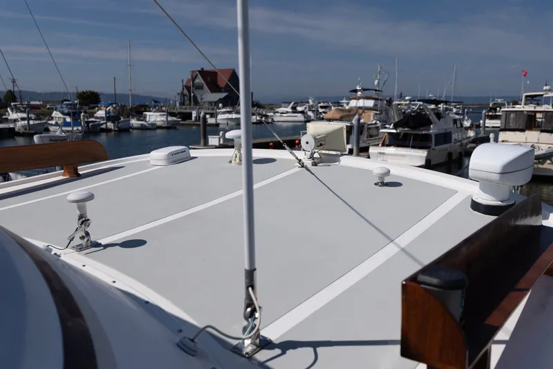 Slide: The Image of Kadey-Krogen 42 yacht, 1990 model, docked at a marina with clear skies. - 52