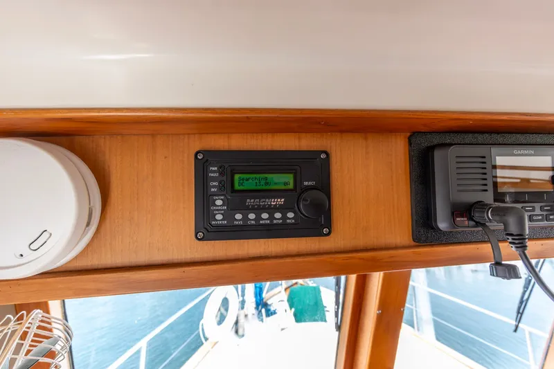 Slide: The Image of Control panel on a 1990 Kadey-Krogen 42 boat, featuring navigation and communication equipment. - 39