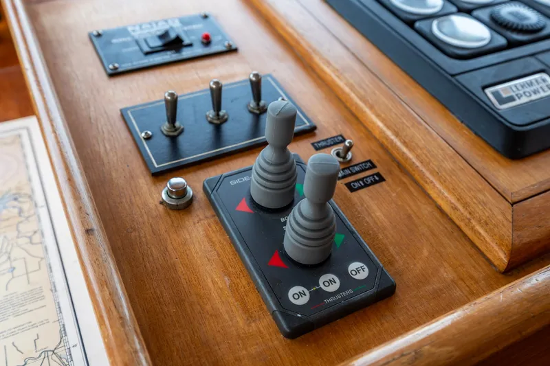Slide: The Image of Control panel of a 1990 Kadey-Krogen 42 boat with switches and joysticks. - 30