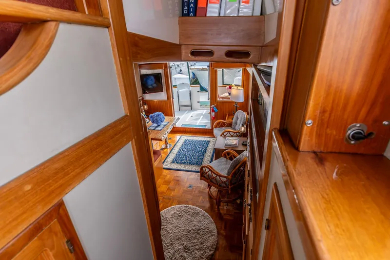 Slide: The Image of Interior view of 1990 Kadey-Krogen 42 yacht, featuring wooden decor and cozy seating area. - 15