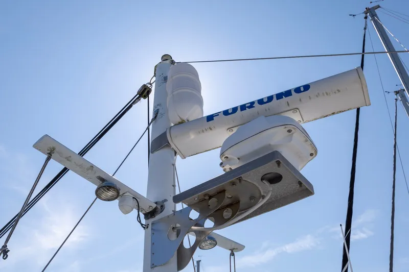 Slide: The Image of Radar equipment on a 1990 Kadey-Krogen 42 yacht under a clear blue sky. - 56