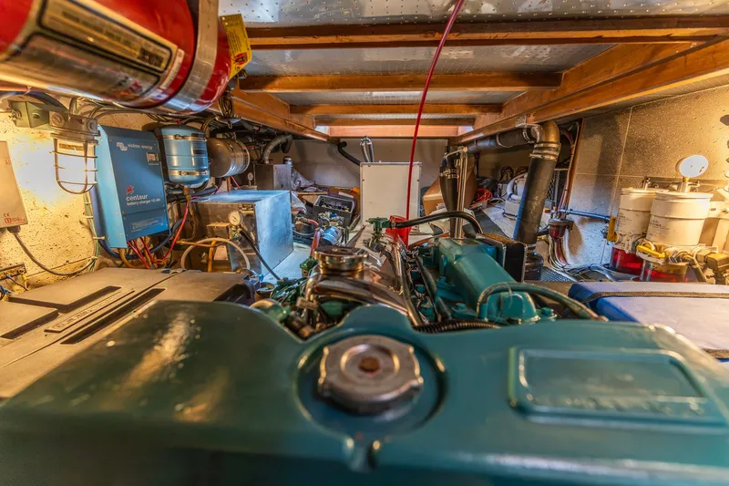 Slide: The Image of Engine room of a 1990 Kadey-Krogen 42 yacht, showcasing mechanical components and equipment. - 50