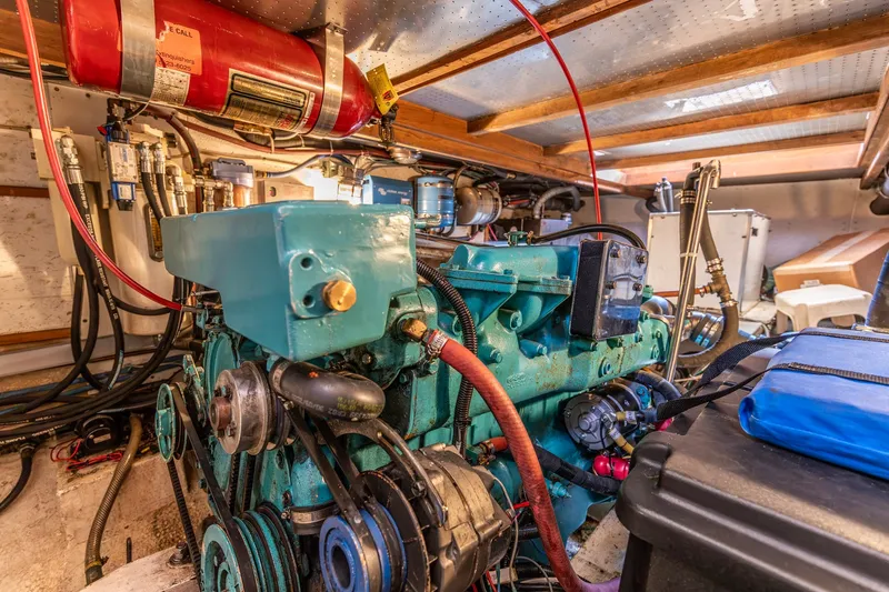 Slide: The Image of Engine room of a 1990 Kadey-Krogen 42 boat, featuring a well-maintained engine. - 49