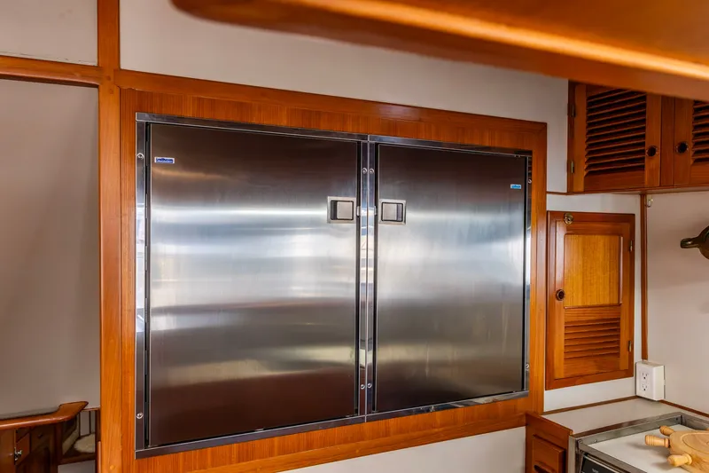 Slide: The Image of Stainless steel refrigerator in 1990 Kadey-Krogen 42 yacht kitchen with wooden cabinetry. - 24