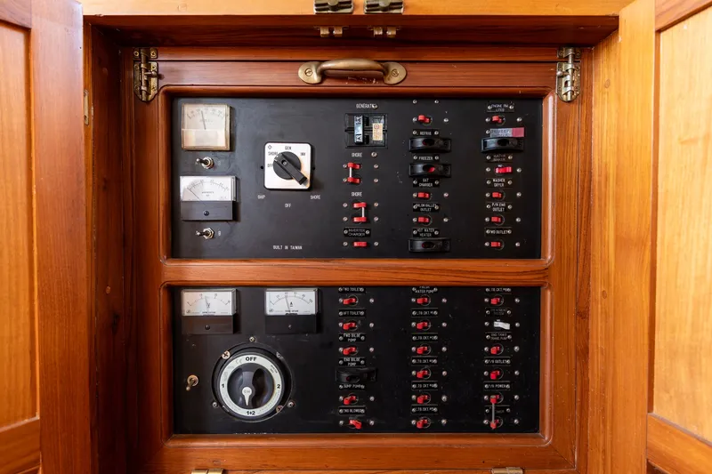 Slide: The Image of Electrical panel inside 1990 Kadey-Krogen 42 boat, featuring switches and gauges. - 21