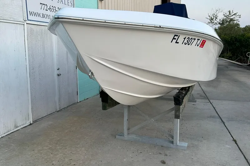 Slide: The Image of 2022 Paramount 21 boat on stand, white hull, registration FL 1307 TJ. - 3
