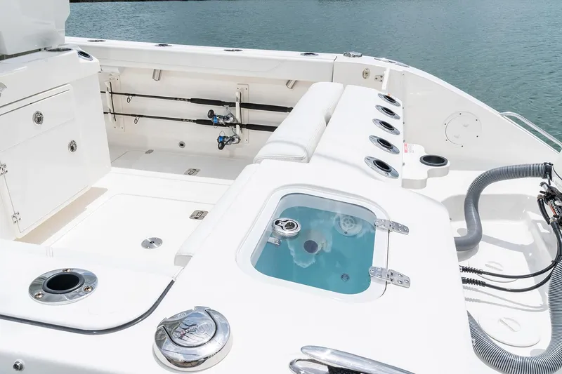 Slide: The Image of Manufacturer Provided Image: 2022 Pursuit S 268 Sport boat interior with fishing rod holders and livewell. - 39