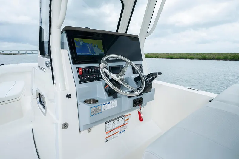 Slide: The Image of Manufacturer Provided Image: 2022 Pursuit S 268 Sport boat helm with navigation system and steering wheel. - 36