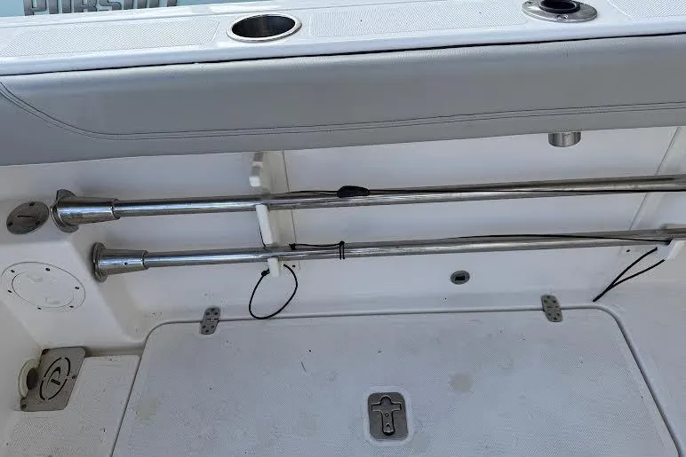 Slide: The Image of 2022 Pursuit S 268 Sport boat interior with rod holders and storage compartment. - 17