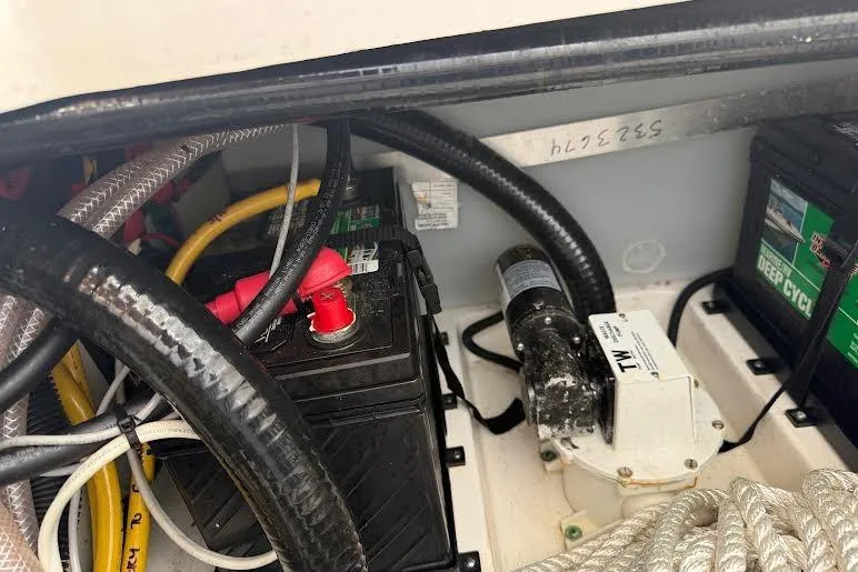 Slide: The Image of 2022 Pursuit S 268 Sport boat battery compartment with cables and deep cycle batteries. - 15