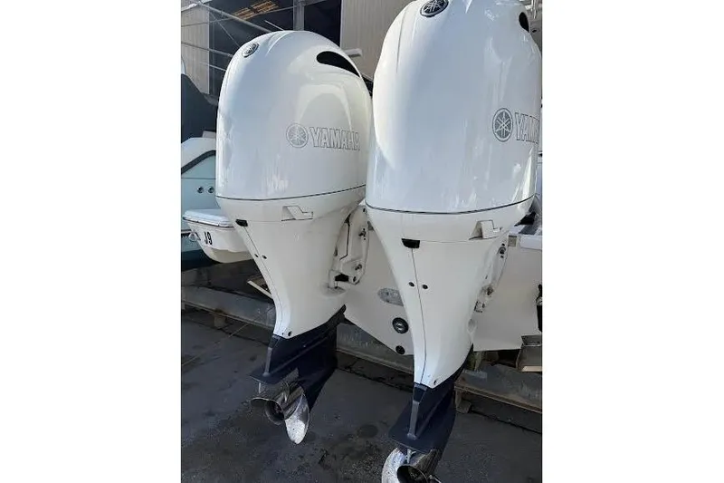 Slide: The Image of Twin Yamaha outboard motors on a 2022 Pursuit S 268 Sport boat. - 27
