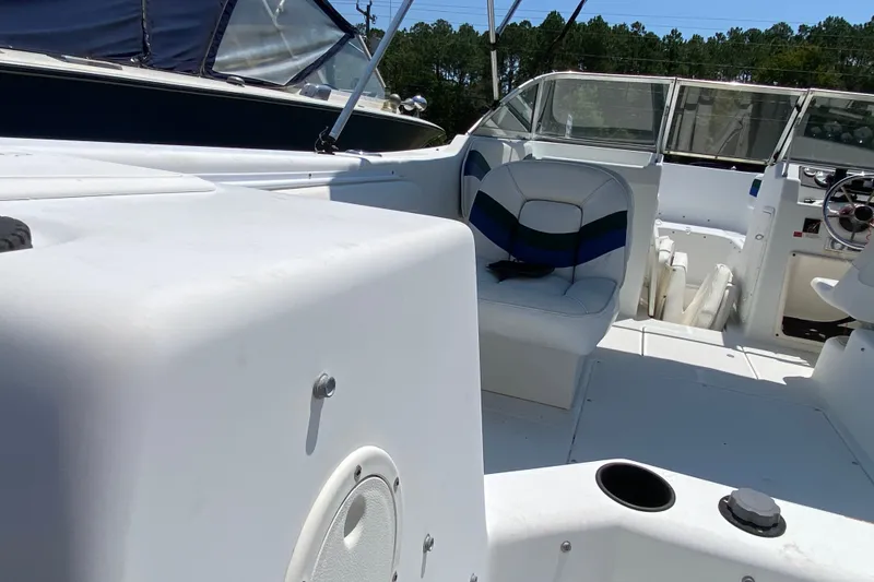 Slide: The Image of Interior view of a 2000 Seaswirl Striper 2100 boat, featuring seating and dashboard. - 6