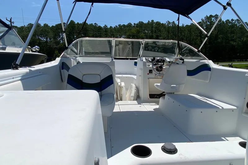 Slide: The Image of Interior view of a 2000 Seaswirl Striper 2100 boat with seating and steering wheel. - 4
