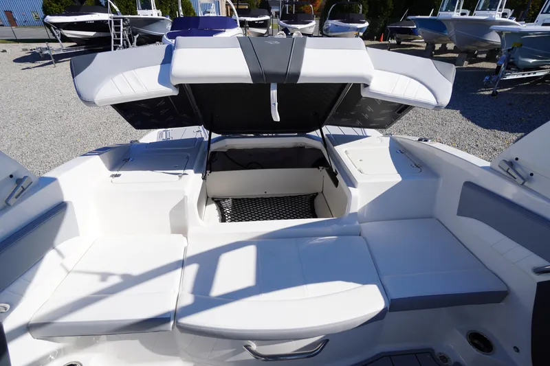 Slide: The Image of 2026 Chaparral 21 SSi OB boat interior with open storage compartment and seating. - 44
