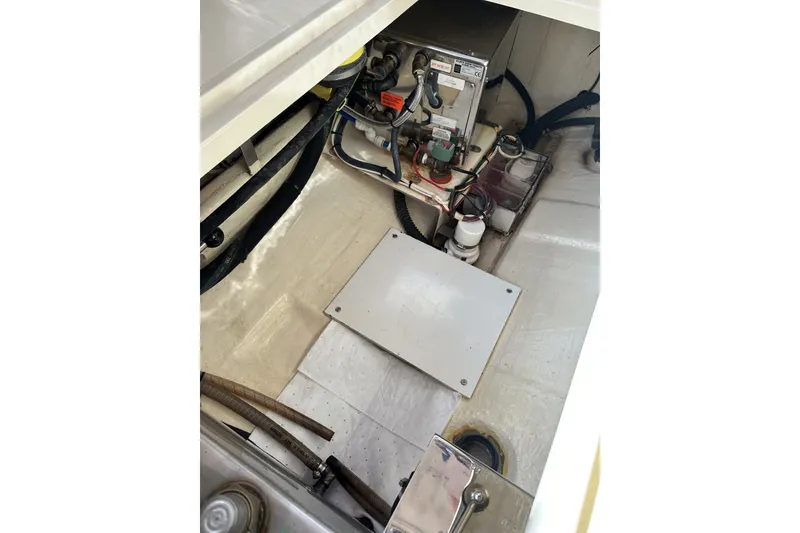 Slide: The Image of Engine compartment of 2005 Hinckley Picnic Boat 36 EP, showcasing mechanical components and wiring. - 32