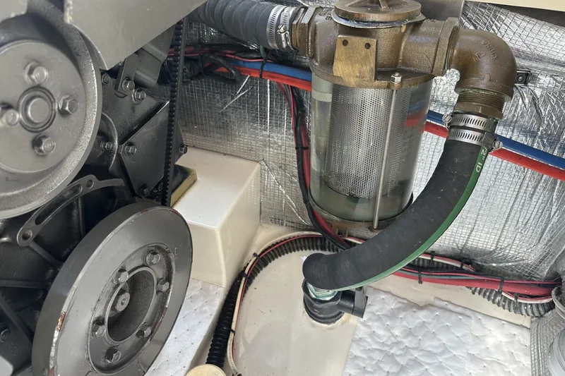 Slide: The Image of Engine compartment of a 2005 Hinckley Picnic Boat 36 EP, showing mechanical components and hoses. - 31