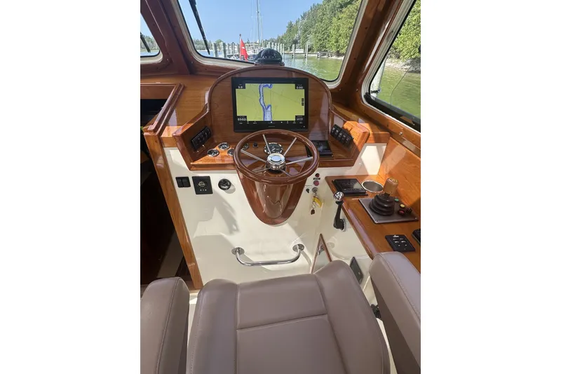Slide: The Image of Helm of 2005 Hinckley Picnic Boat 36 EP with navigation display and wooden steering wheel. - 15