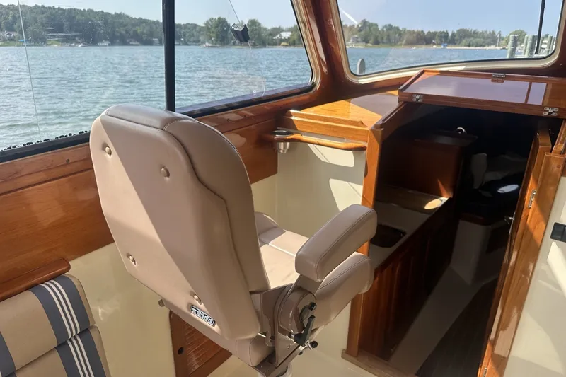 Slide: The Image of Interior of 2005 Hinckley Picnic Boat 36 EP with helm seat and cabin view. - 18