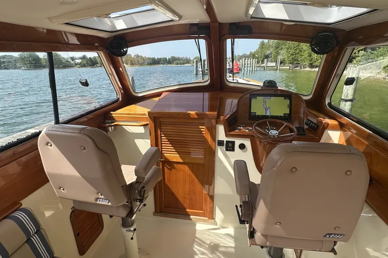 Slide: The Image of Interior of 2005 Hinckley Picnic Boat 36 EP with wooden dashboard and navigation system. - 14